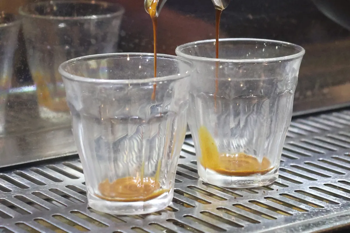 Espresso pouring into two glasses