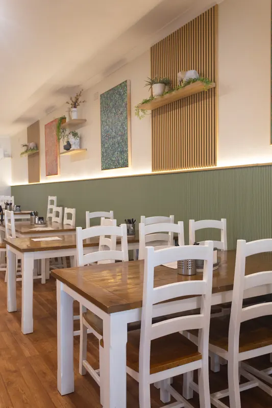 The dining room, with timber tables and white chairs