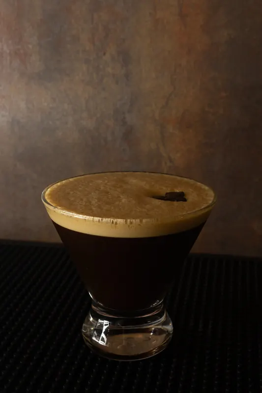 An espresso cocktail in a coupe glass