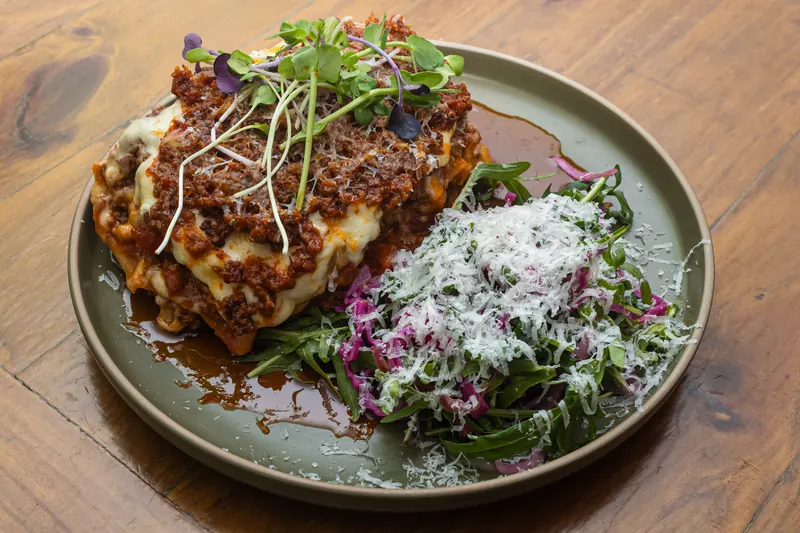 Lasagna with rocket salad and parmesan