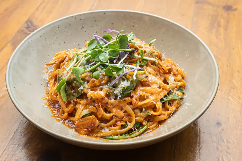 Pink pasta with parmesan and micro herbs