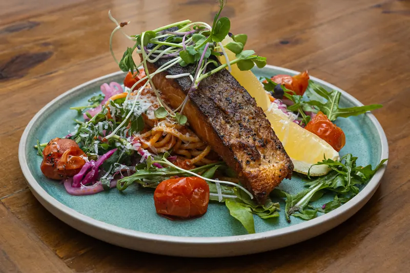 Pan-fried salmon with pasta, cherry tomatoes and rocket