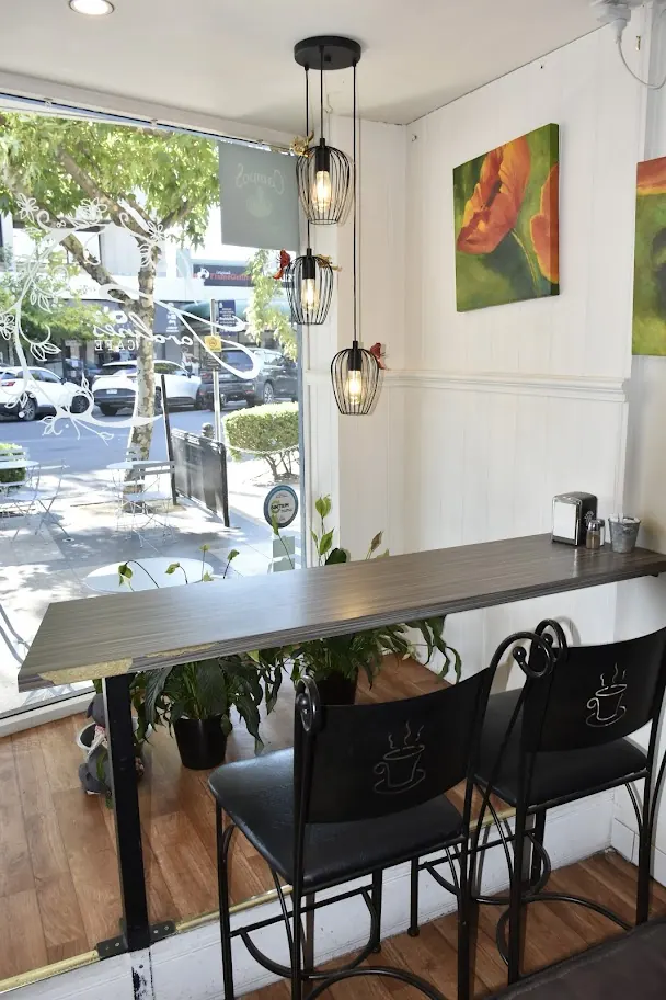 Window bar seating with pendant lights and poppy paintings